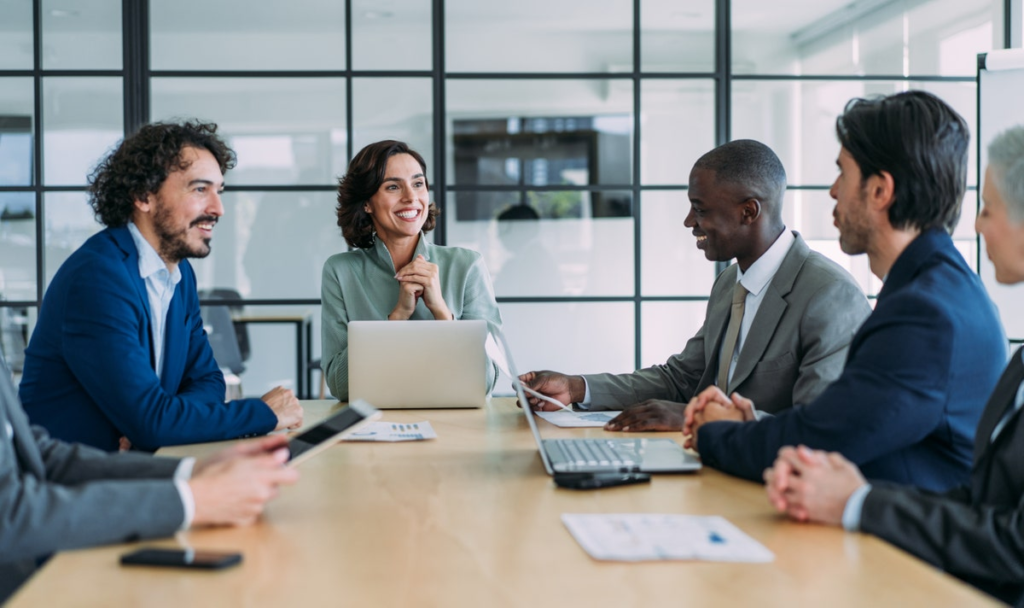 Professionals reviewing AI use and compliance in a meeting